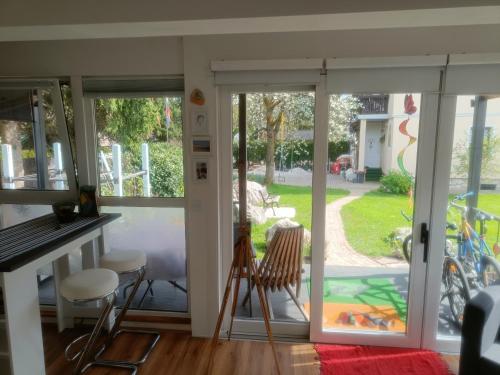 an open door to a patio with a view of a yard at ArtRock Studio in Radovljica
