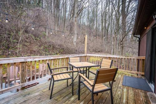 a porch with a table and chairs on a deck at Mountain Views, Hot Tub, Firepit, dog friendly, EV connector in Stanley