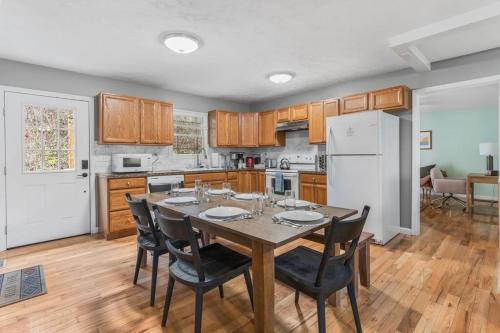 a kitchen with a table and chairs and a refrigerator at Mountain Views, Hot Tub, Firepit, dog friendly, EV connector in Stanley