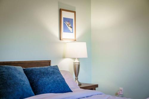 a bedroom with a bed and a lamp and a picture at Mountain Views, Hot Tub, Firepit, dog friendly, EV connector in Stanley