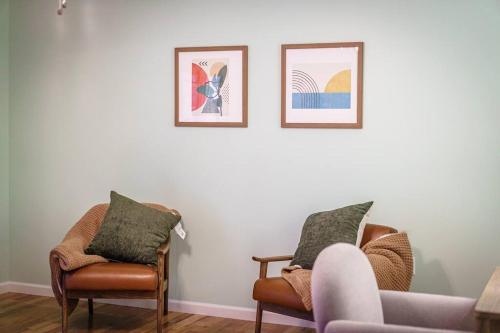 a living room with two chairs and a couch at Mountain Views, Hot Tub, Firepit, dog friendly, EV connector in Stanley