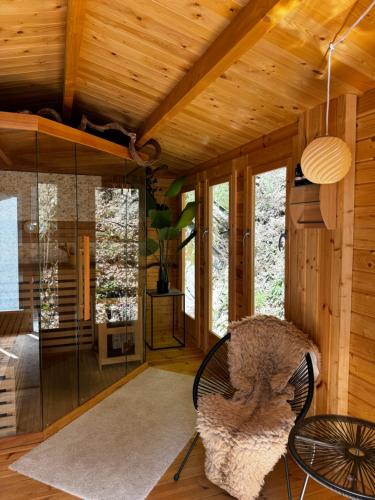 a living room with a chair and a table at Schlosshotel Brilon-Wald in Brilon-Wald