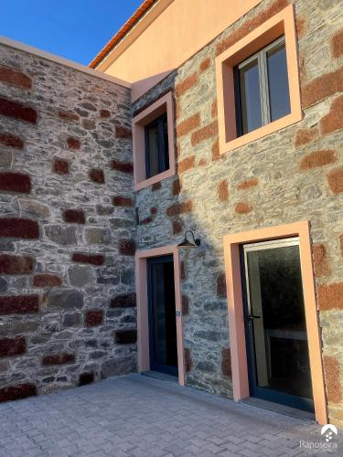 a building with two doors on the side of it at Raposeira Country House in Calheta