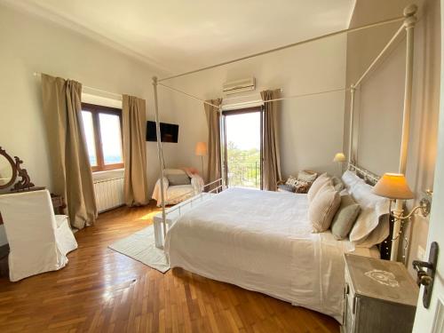 a bedroom with a large bed with a metal canopy at “Casa Amélie” in Grottaferrata