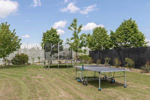 a ping pong table in the middle of a yard at Memento B&B in Cociarone