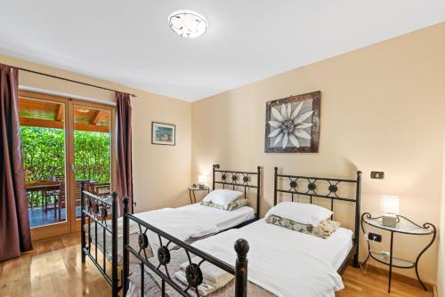 two beds in a bedroom with a balcony at Villa Dol an ideal spa and wellness escape in Istria in Buzet