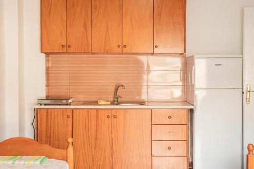 a kitchen with a sink and a refrigerator at Coastal Bliss Apartment in Himare