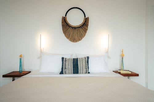 a bedroom with a bed with a mirror on the wall at Melianthos Villas in Vathi, Sifnos