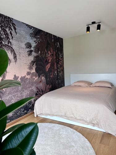 um quarto com uma cama e um mural de parede em Luxurious flat offering comfort and privacy in Martelange em Martelange