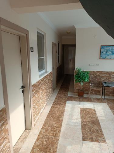 a hallway with a door and a table and a plant at Pamukkale Sahin Hotel in Pamukkale