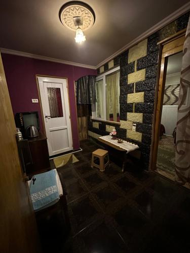 a room with a room with a door and a table at Guest House Iura in Sighnaghi