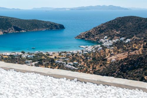 an aerial view of a road next to the ocean at Melianthos Villas in Vathi, Sifnos