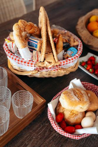 two baskets of bread and other foods on a table at Melianthos Villas in Vathi, Sifnos