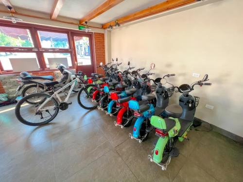 a row of scooters and motorcycles parked in a room at Cánh Buồm Homestay - Tuần Châu in Ha Long