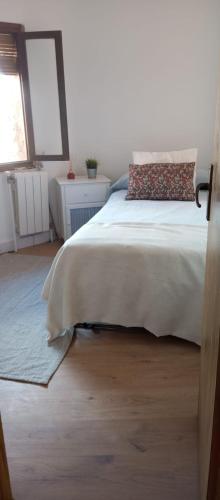 a bedroom with a bed and a window at El Cantón del Cerrillo in Cornago