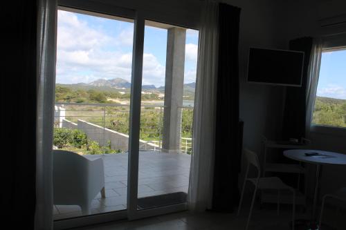 a room with a sliding glass door to a balcony at LIDO DEL FARO in Olbia
