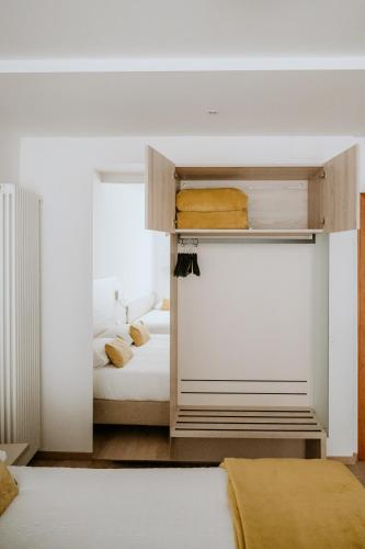 a small bedroom with two beds and a closet at Hotel Venezia in Trento