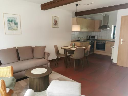 a living room with a couch and a table at Beekenhof in Bommelsen