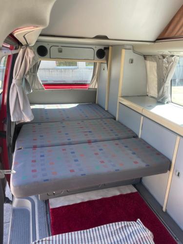 A bed or beds in a room at Camper car in underground parking