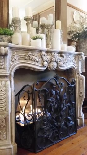 an ornate fireplace in a living room with candles at A La Maison Boutique Guesthouse in Parys