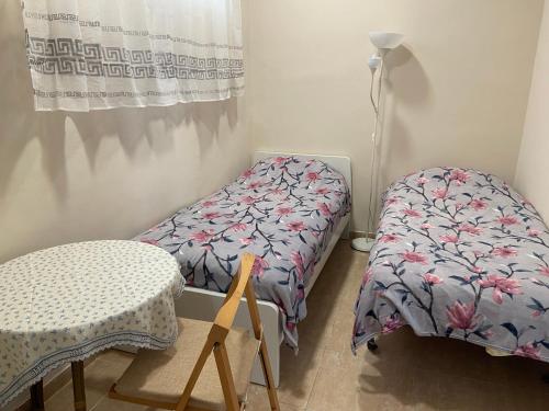 a room with two beds and a table and a lamp at Casa Valencia in Valencia