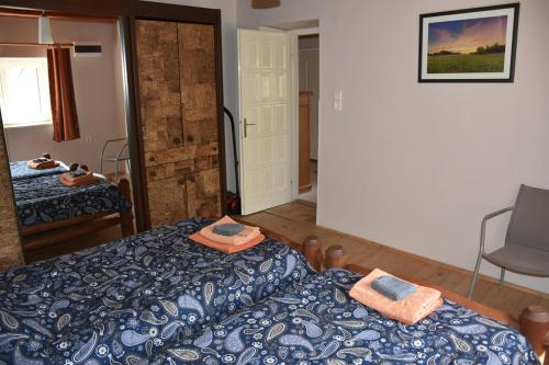 a bedroom with a bed and towels on top of it at Boróka Tanya in Orgovány