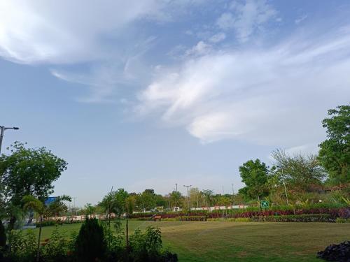 a green park with trees and a cloudy sky at Fortune Statue Of Unity, Ekta Nagar - Member ITC Hotels' Group in Kevadia