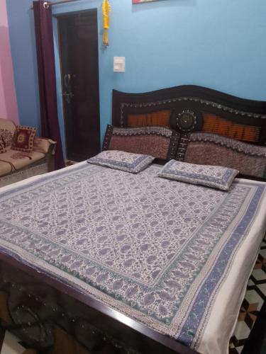 a bed with two pillows on it in a room at Bhatt Home Stay in Kishanpur