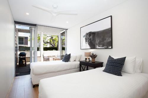 uma sala de estar com duas camas e um sofá em Bellevue Beauty em Sidney