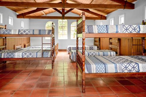 a bedroom with four bunk beds in a room at Paradisiacal getaway -Serra Negra in Serra Negra
