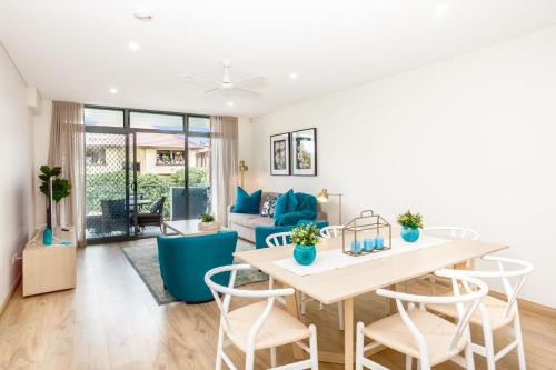 a living room with a table and chairs and a couch at Blissful Bream in Sydney