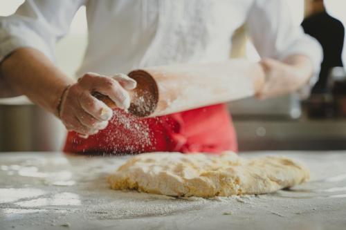 a person is making some food on a table at Hotel Semriacherhof in Semriach
