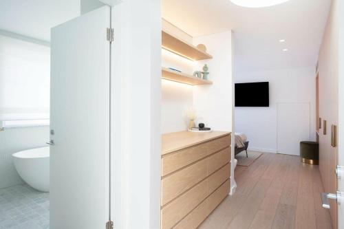 a bathroom with a sink and a toilet and a tub at Bondi Casa del Sol in Sydney
