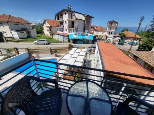 a balcony with chairs and a view of a street at Villa Pegasus Pestani in Ohrid