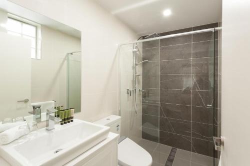 a bathroom with a sink and a shower at Bream Penthouse in Sydney