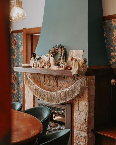 a living room with a fireplace with a mantel at Vibrant Dual Retreat Vagabond s Rest Rose Gold Hideaway in Kings Park