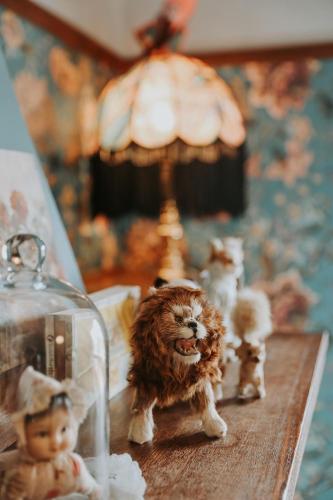 a toy dog and dolls on a table at Vibrant Dual Retreat Vagabond s Rest Rose Gold Hideaway in Kings Park