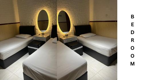 a room with three beds and two mirrors at Villa Morphosis in Berpodak