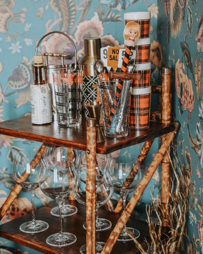 a shelf with wine glasses and other items on it at Vibrant Dual Retreat Vagabond s Rest Rose Gold Hideaway in Kings Park