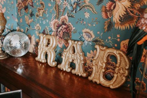 a wooden table with the word radio on a wall at Vibrant Dual Retreat Vagabond s Rest Rose Gold Hideaway in Kings Park