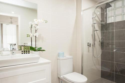 uma casa de banho com um chuveiro, um WC e um lavatório. em Charming Bream em Sydney