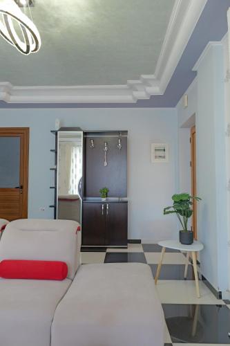a bedroom with two beds and a table at Vila Nanaj in Sarandë