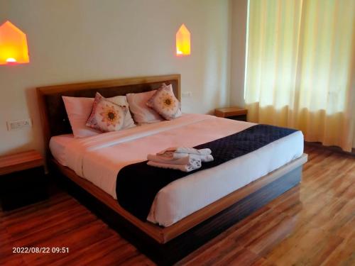 a bedroom with a large bed with pink pillows at Vacation Village Camps - A Unit Of Braham Vatika Resort in Pushkar
