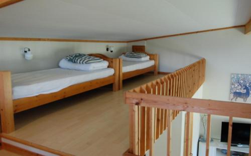 two bunk beds in a room with a staircase at Alcatraz in Gustavsfors