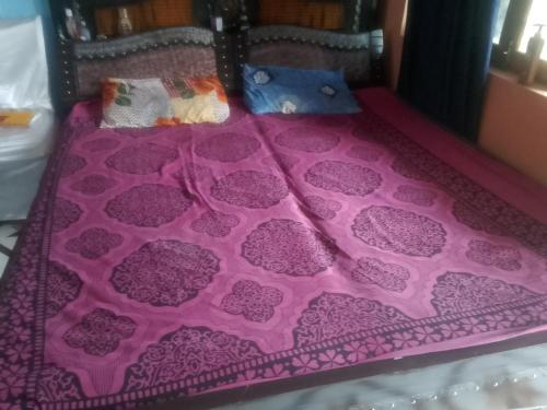a bed with a pink blanket with hearts on it at Bhatt Home Stay in Kishanpur