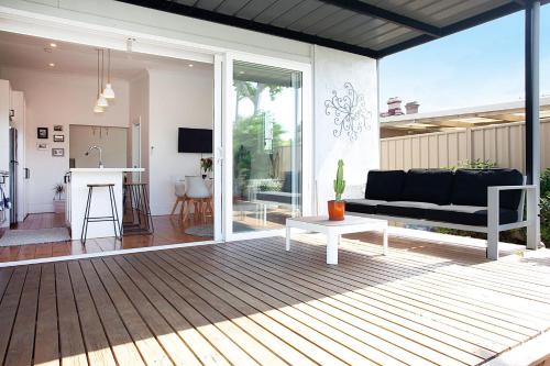 a living room with a couch and a table at Garden Oasis Sydenham in Sydney