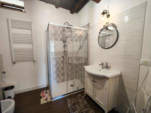 a bathroom with a shower and a sink and a mirror at La Staccionata in Arpino