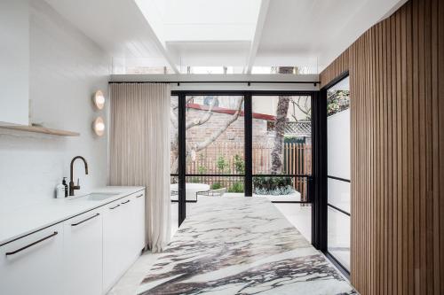 a kitchen with a sink and a large window at The Timeless Modern Glebe in Sydney