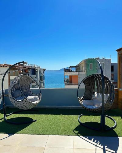 two wicker chairs sitting on top of a roof at Luxury Rooftop Vlora in Vlorë