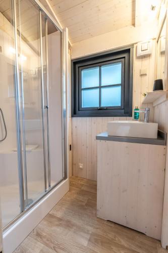 a bathroom with a sink and a shower at Hôtel Quai des Pontis in Cognac